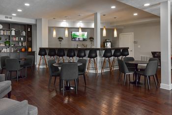 A room with a long table and chairs.